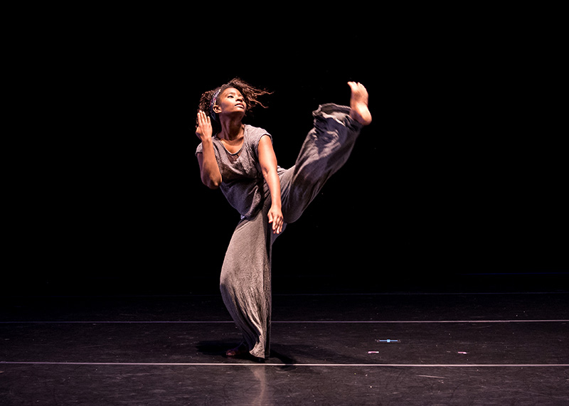 Melanie does a kick forward onstage.